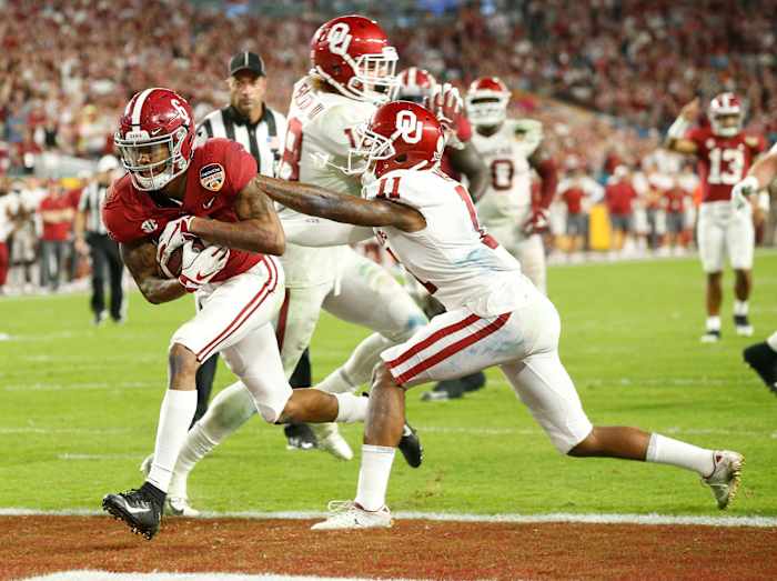 Alabama wide receiver DeVonta Smith (6) rips past Oklahoma cornerback Parnell Motley (11) for a touchdown during the Tide's 45-34 win in the 2018 College Football Playoff Semifinal at the Capitol One Orange Bowl in Miami Gardens, Florida Saturday, Dec. 29, 2018.